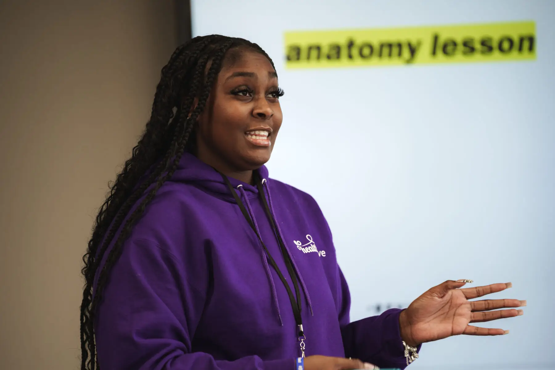 Close-up of woman presenting in front of smart whiteboard.